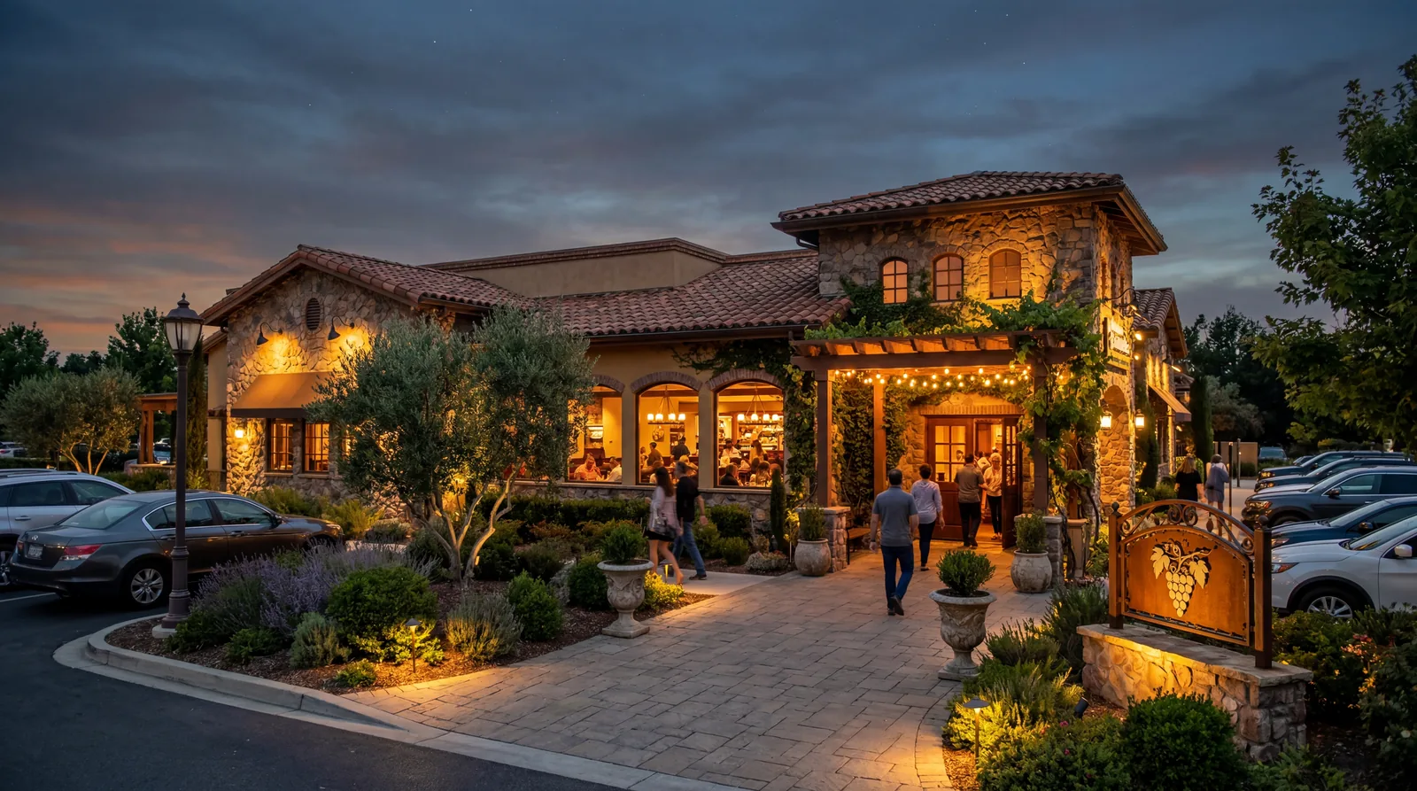 An Olive Garden-style Italian casual dining restaurant exterior at dusk with warm interior lighting glowing through windows, photorealistic, no text, no watermark, 16:9