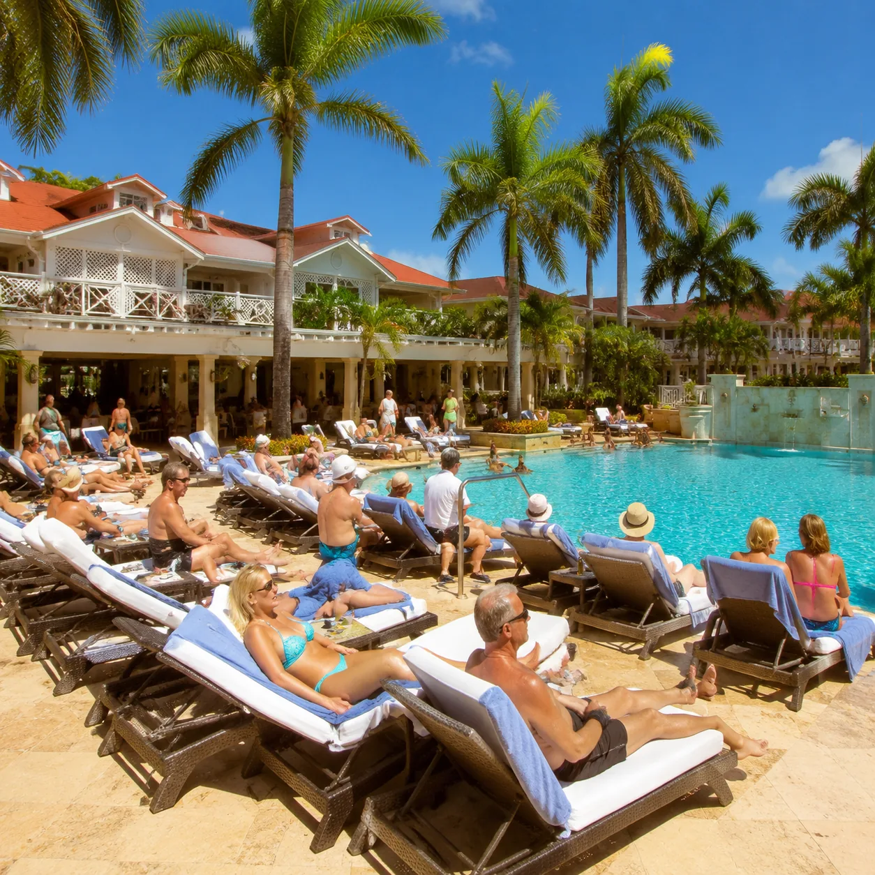 Realistic editorial photo of cruise excursion group in sun hats near a tropical port bus, water bottles and sunscreen vi