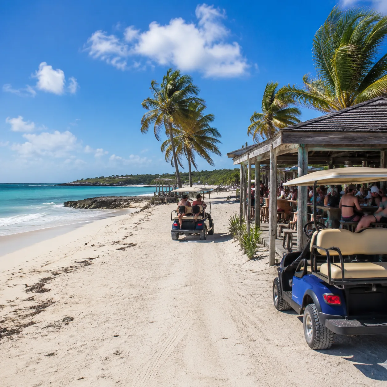 Great Guana Cay Abaco Bahamas beach with beach bar, golf carts, Atlantic surf, casual island scene