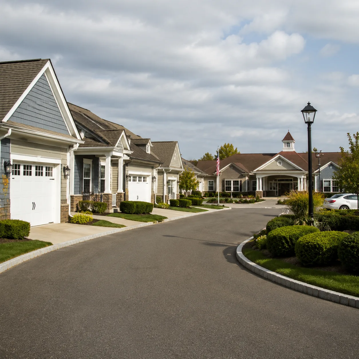Realistic editorial photo of a quiet New Jersey coastal retirement community street with attached homes, a clubhouse ent