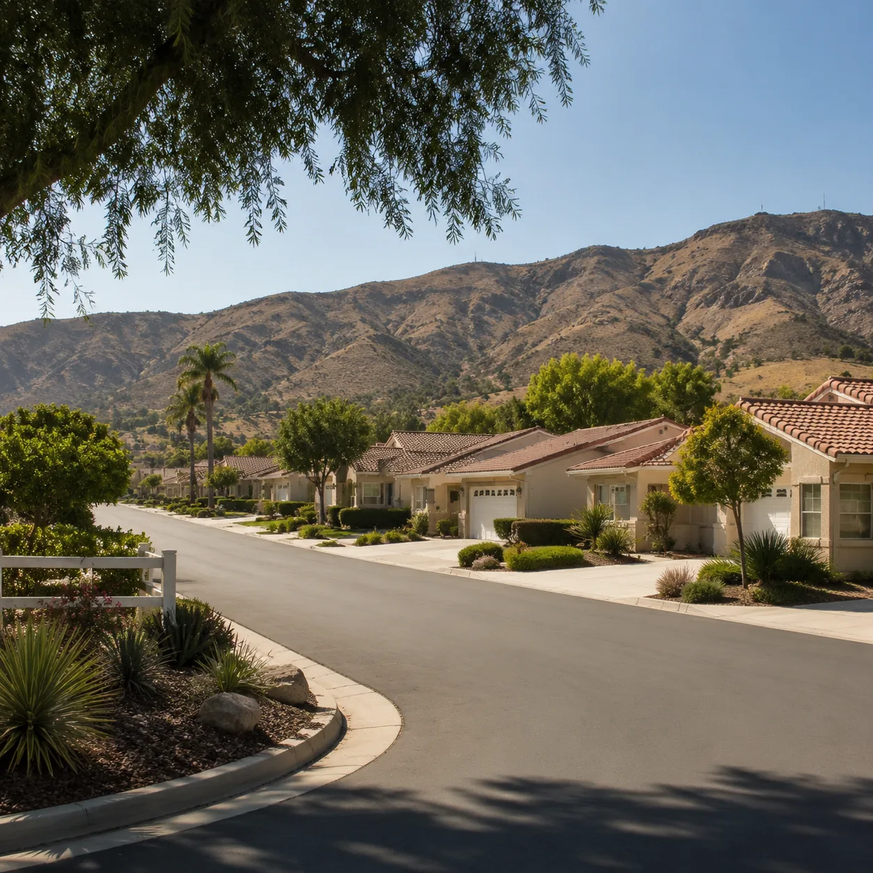 Realistic editorial photo of an Inland Empire retirement community with dry hills, single-story homes, wide streets, and