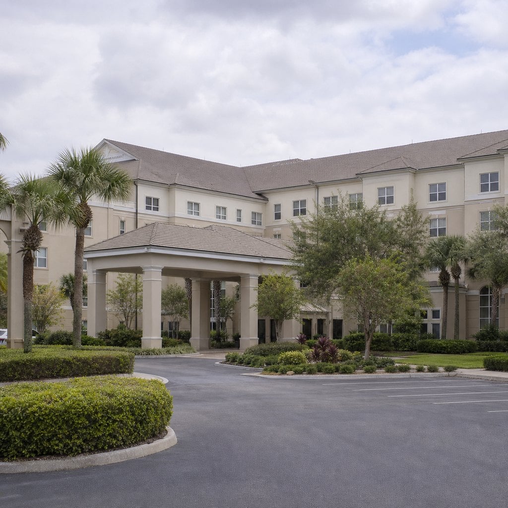 Fresh square editorial photo of a continuing care retirement community building in Florida with institutional architecture, q