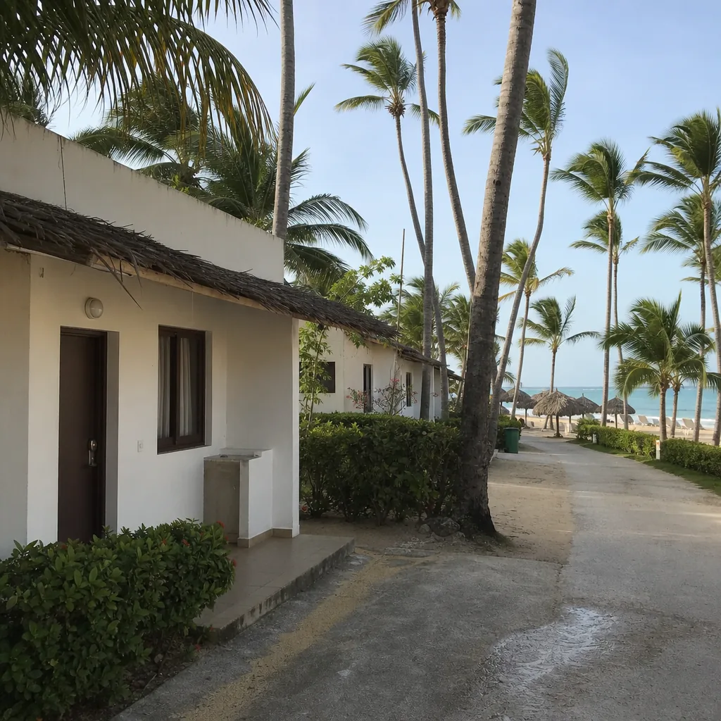 Realistic editorial photo of Punta Cana all-inclusive resort scene showing lowest price room near service roads, palms a